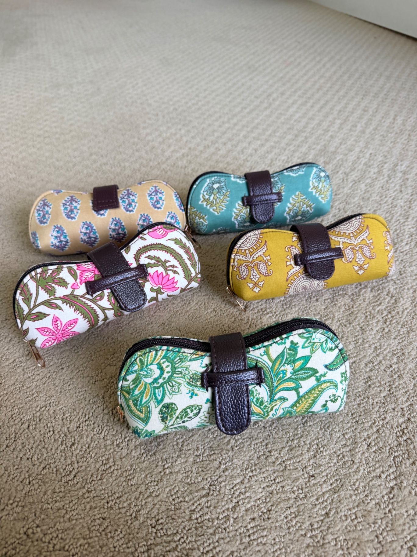 Five Varnya block-print glasses cases — beige, teal, pink floral, mustard paisley and green paisley