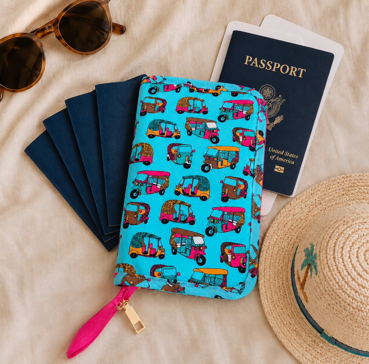 Turquoise auto-rickshaw print Varnya family passport holder with five passports, sunglasses and a sun hat