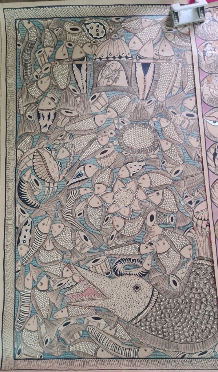 A Pattachitra painting of a fish wedding — a large fish at the centre surrounded by many smaller fish, with two fish dressed as bride and groom under decorated canopies at the top.
